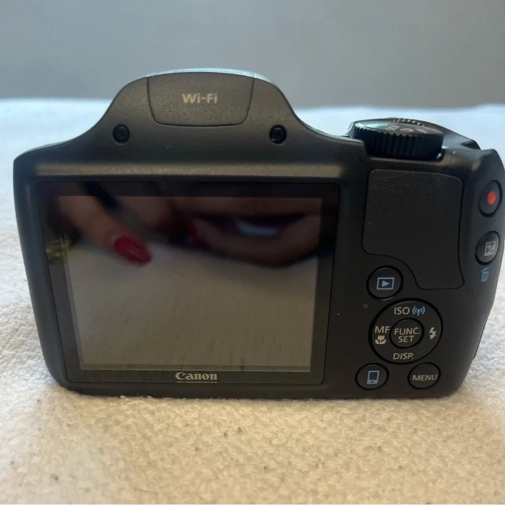 Canon Black Digital Camera with Large Zoom Lens and Textured Grip